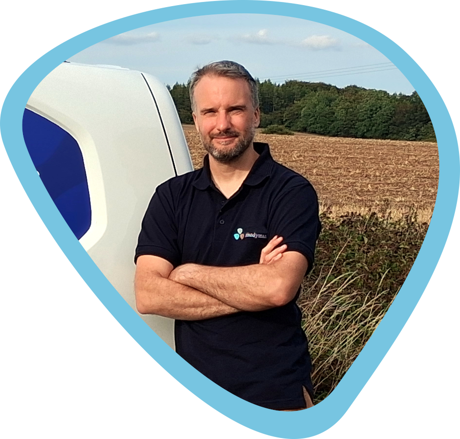 A handyman standing by a van